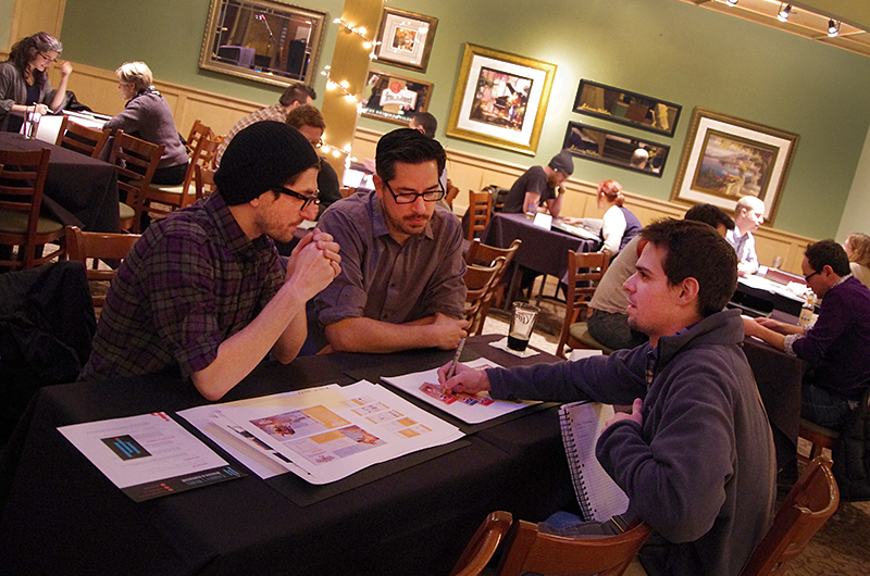 2 Designers review a student's portfolio