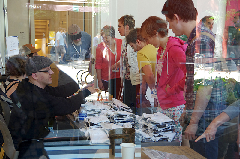 People picking up t-shirts at conference