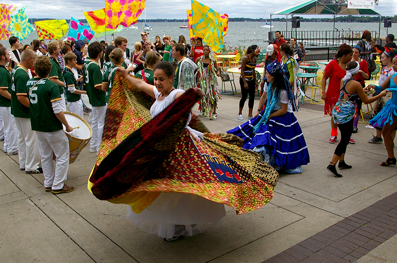 Woman spins in a dress while others dance