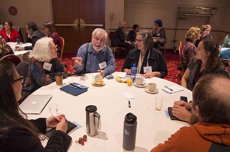 Group of people sitting around a round table