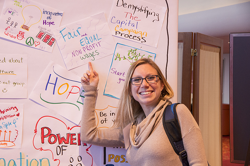 Woman points to a sign she made