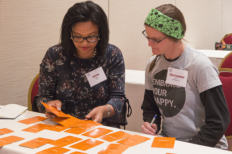 Two women working with cards