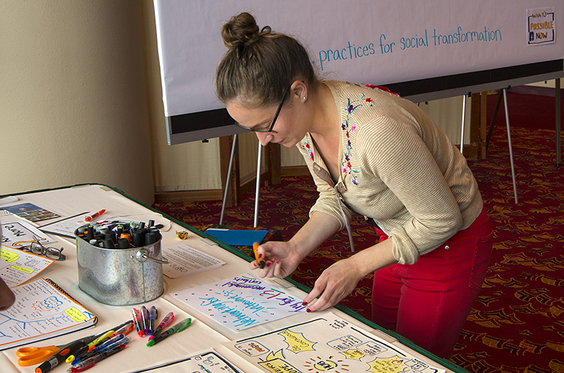 Woman making a sign with color markers