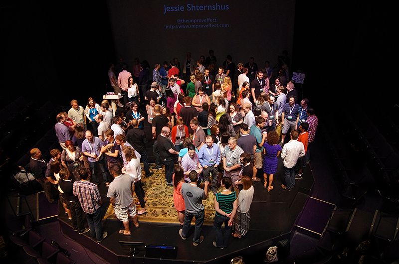 Audience on stage greeting each other