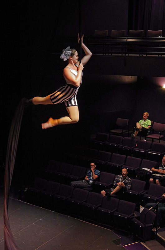 Woman swinging on a silk ribbon